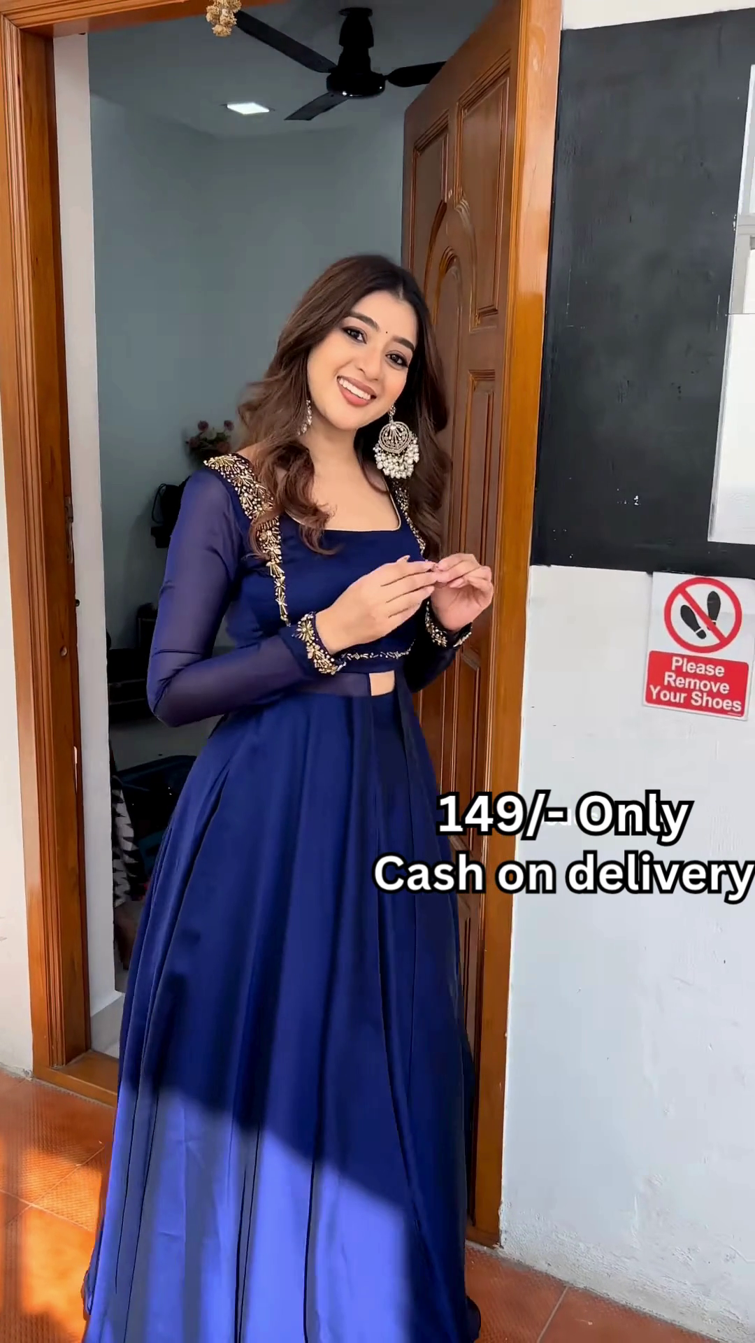 Women’s Red Embroidered Skirt Top Set with Traditional Earrings – Ethnic Doorway Portrait Ensemble