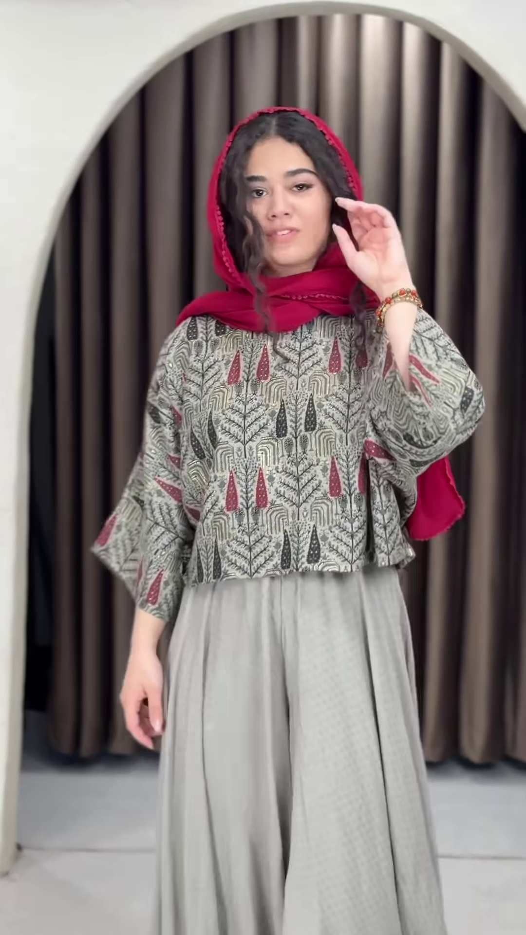 Women’s Red Printed Headscarf with Abstract Top & Gray Wide-Leg Pants – Boho Urban Doorway Portrait Ensemble