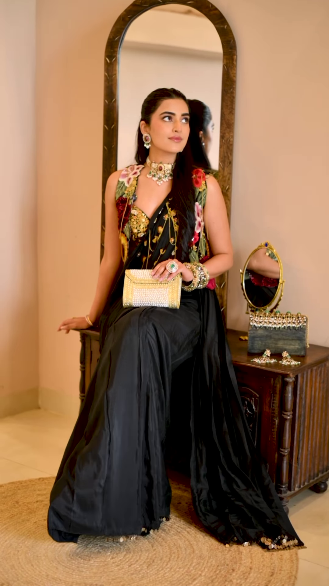 Women’s Black Saree with Gold Embellishments & Pleated Draping – Elegant Ethnicwear Styled with Traditional Bracelet