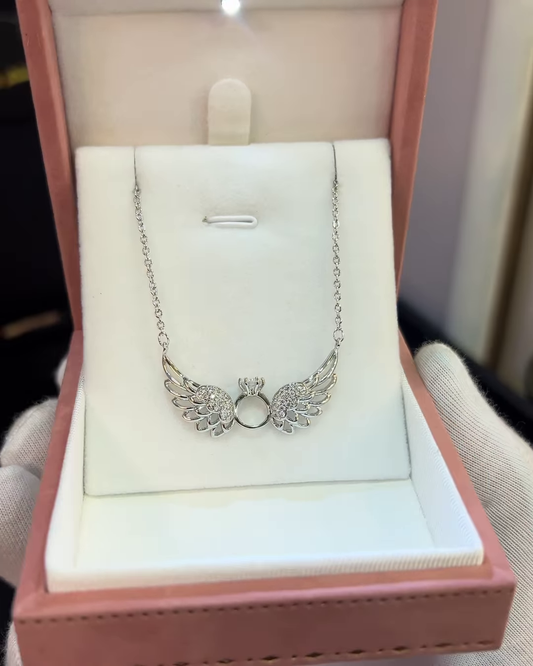 Elegant Silver-Toned Angel Wing Pendant Necklace with Ring Detail and Sparkling Accents